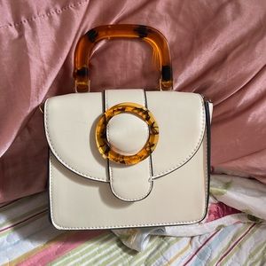 White with tortoise handle purse